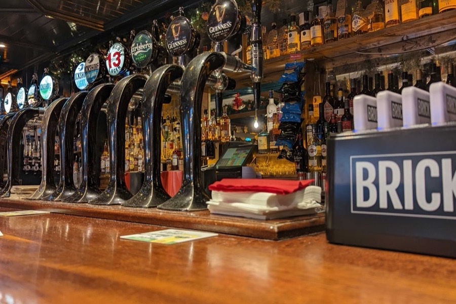 A Brick station on a bar counter among the beer taps