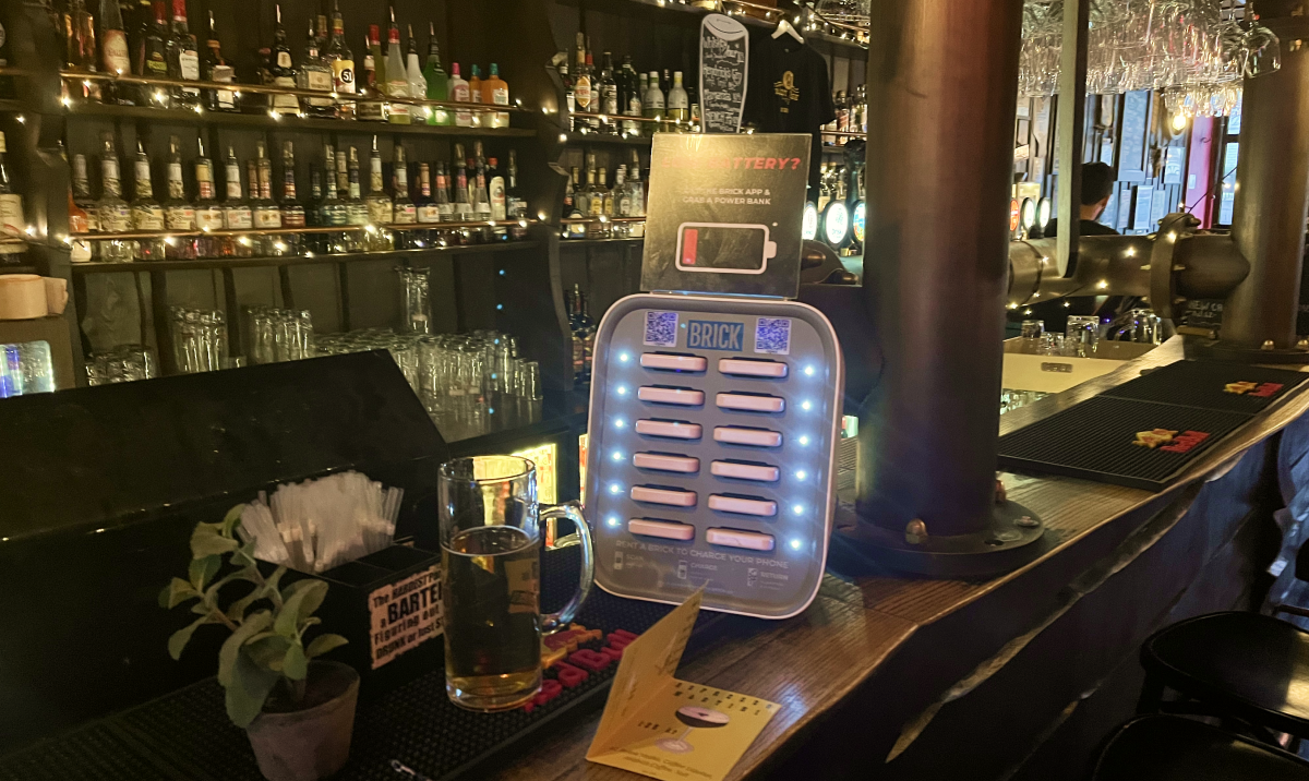 A brick powerbank sharing station placed on a bar