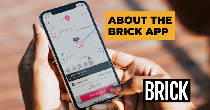 Hand holding a phone showing a screenshot of the Brick App